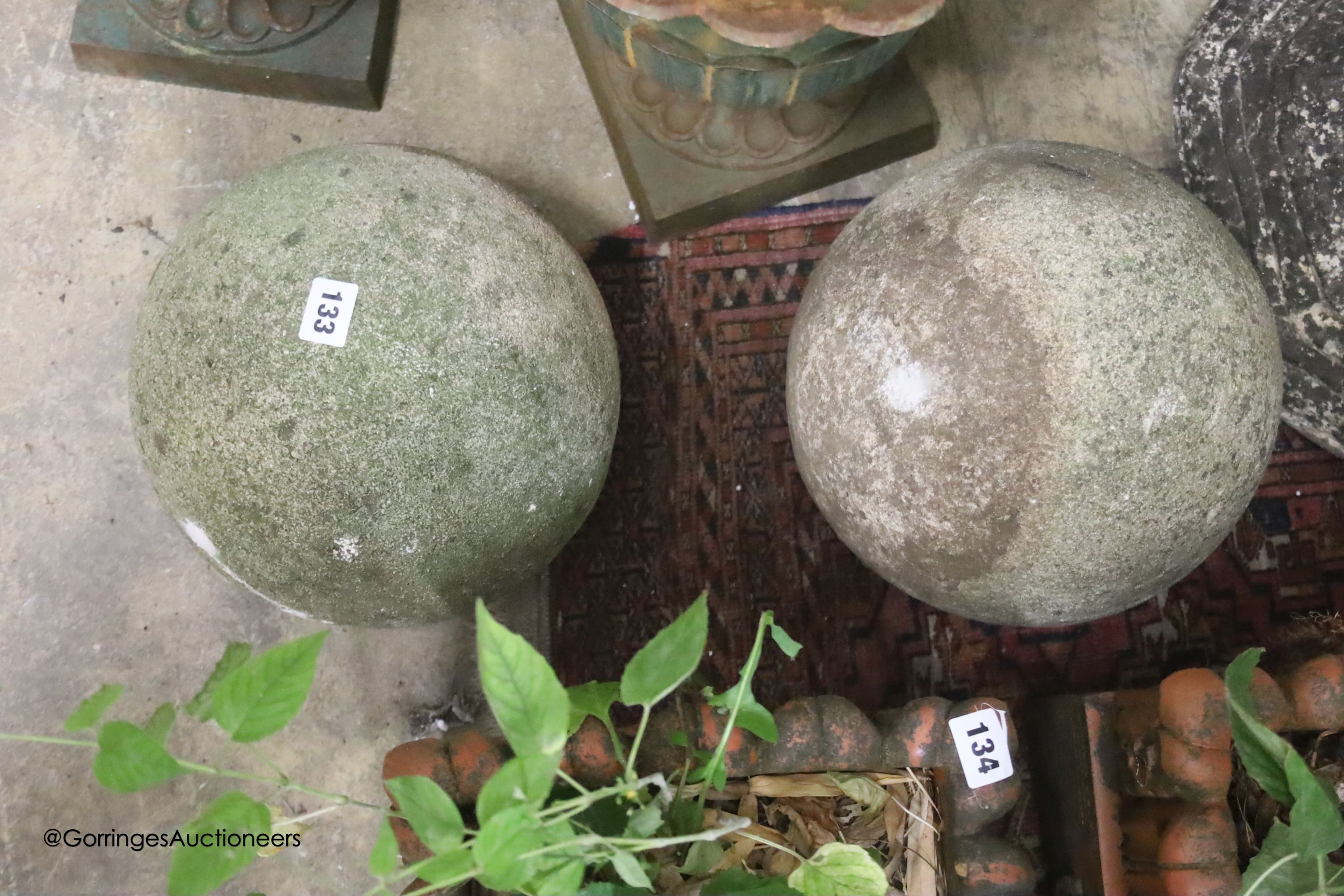 A pair of reconstituted stone spherical garden ornaments, height 24cm